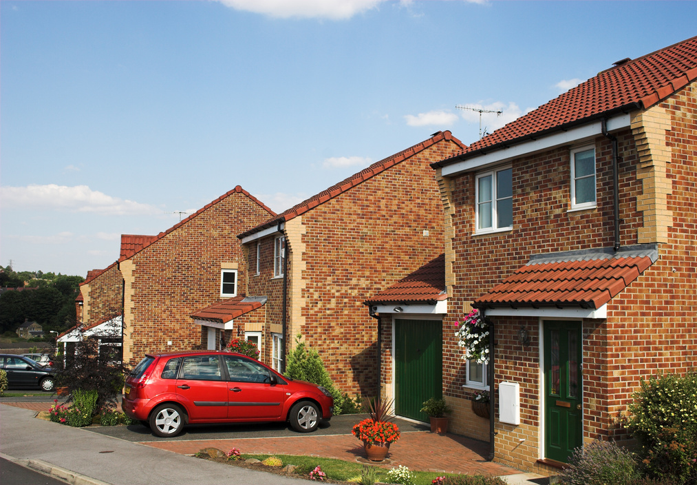 Modern suburban family houses with car on driveway